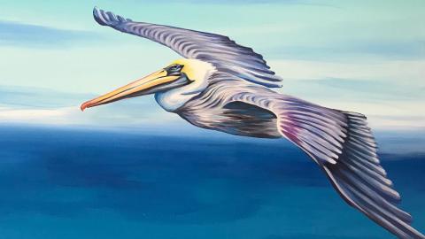 Painting of pelican soaring over ocean