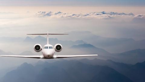 Fly Friendly cover photo - airplane flying over mountains and clouds