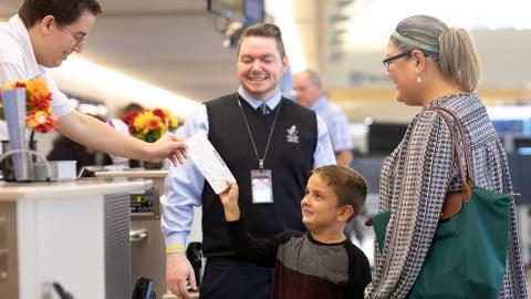 Young boy receiving personalized travel assistance at airport