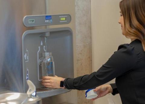 Refilling bottle at water station