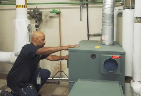 man kneeling to repair electrical box