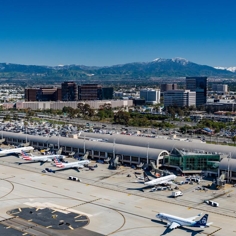 Aerial view of John Wayne Airport, with mountains in background