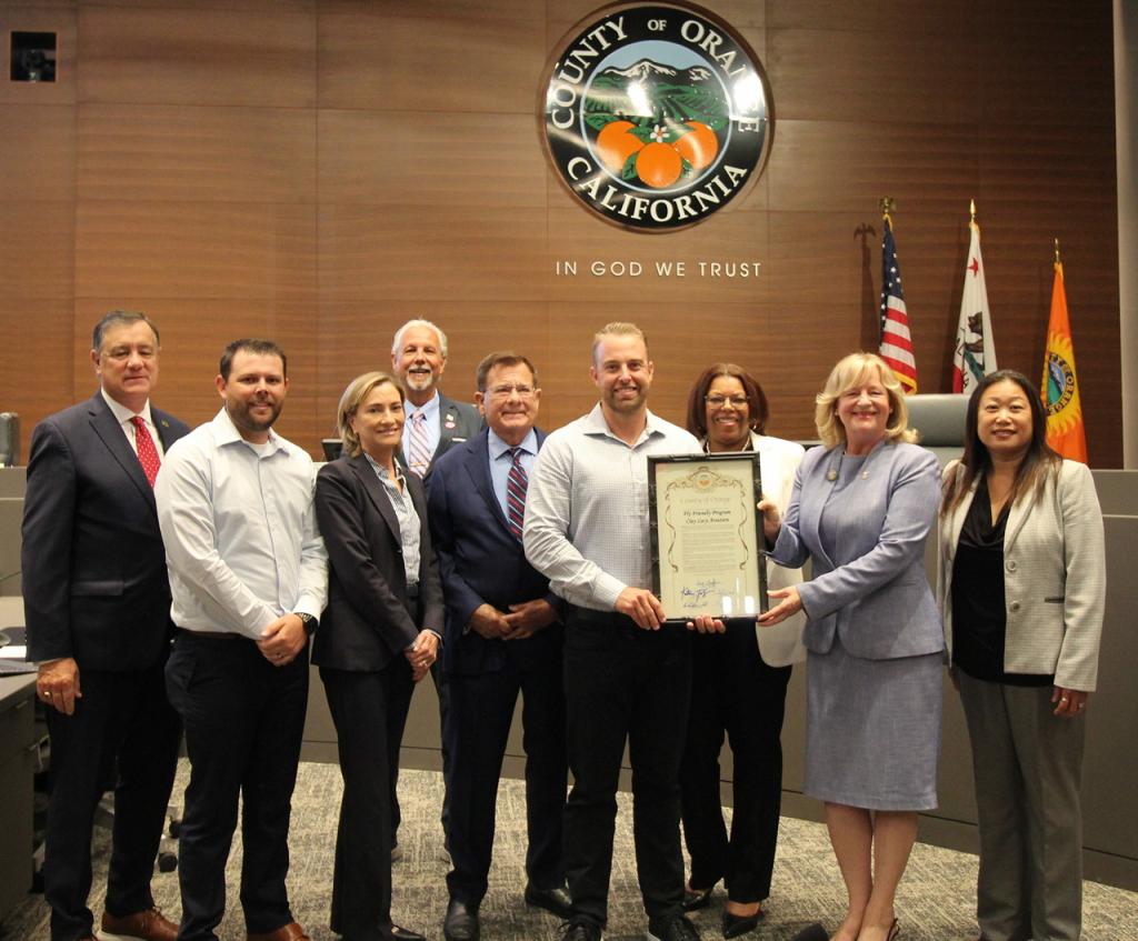 board members standing in a group around a framed resolution