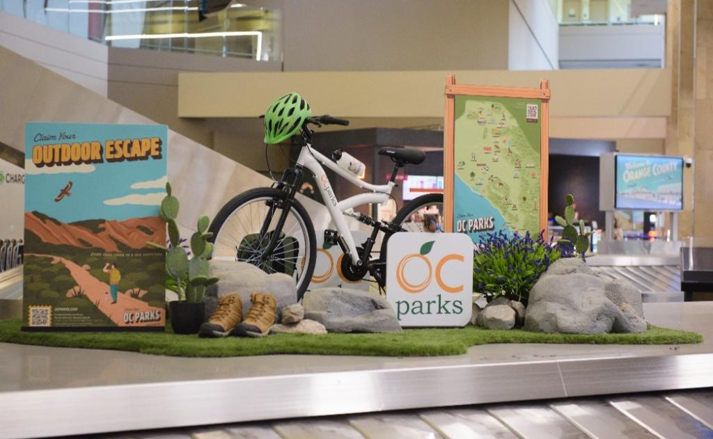 Signs, outdoor decoration and bicycle on display above baggage carousel