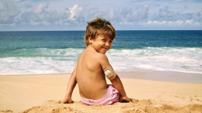 Boy sitting on beach