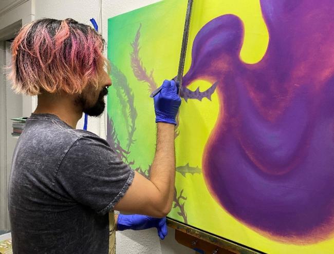 Artist Cody Jimenez working in his studio