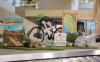 Signs, outdoor decoration and bicycle on display above baggage carousel